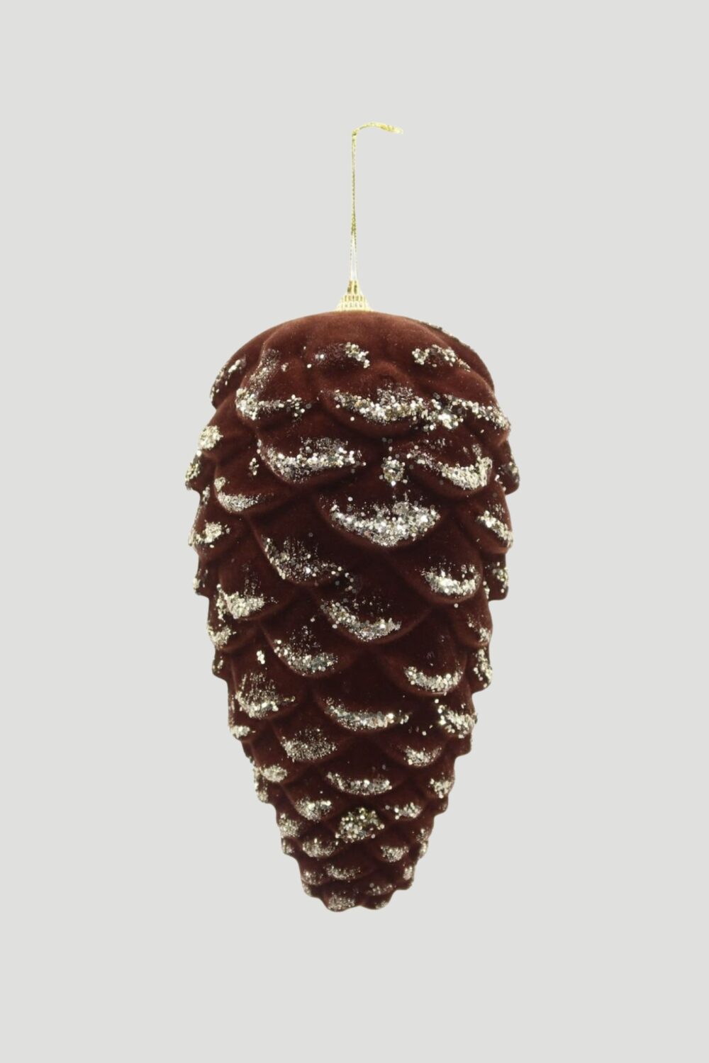 Elongated dark brown pinecone Christmas ornament with glittered scale edges and a gold hanging cord.
