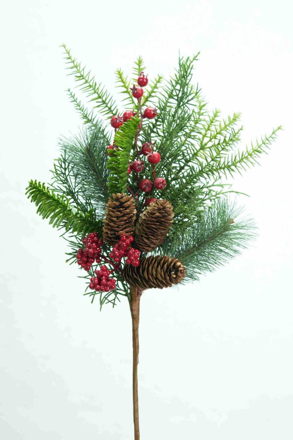 Full view of artificial evergreen Christmas pick with red berries, brown pinecones and mixed green foliage