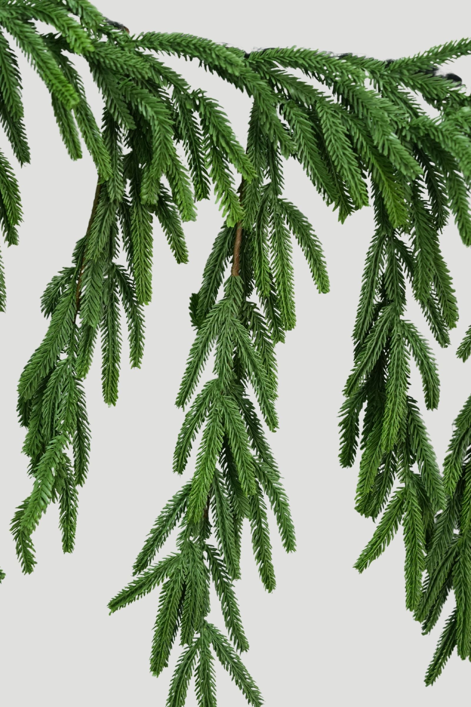 Feel Real Norfolk Pine Mantel Garland with cascading branches and finely textured green needles
